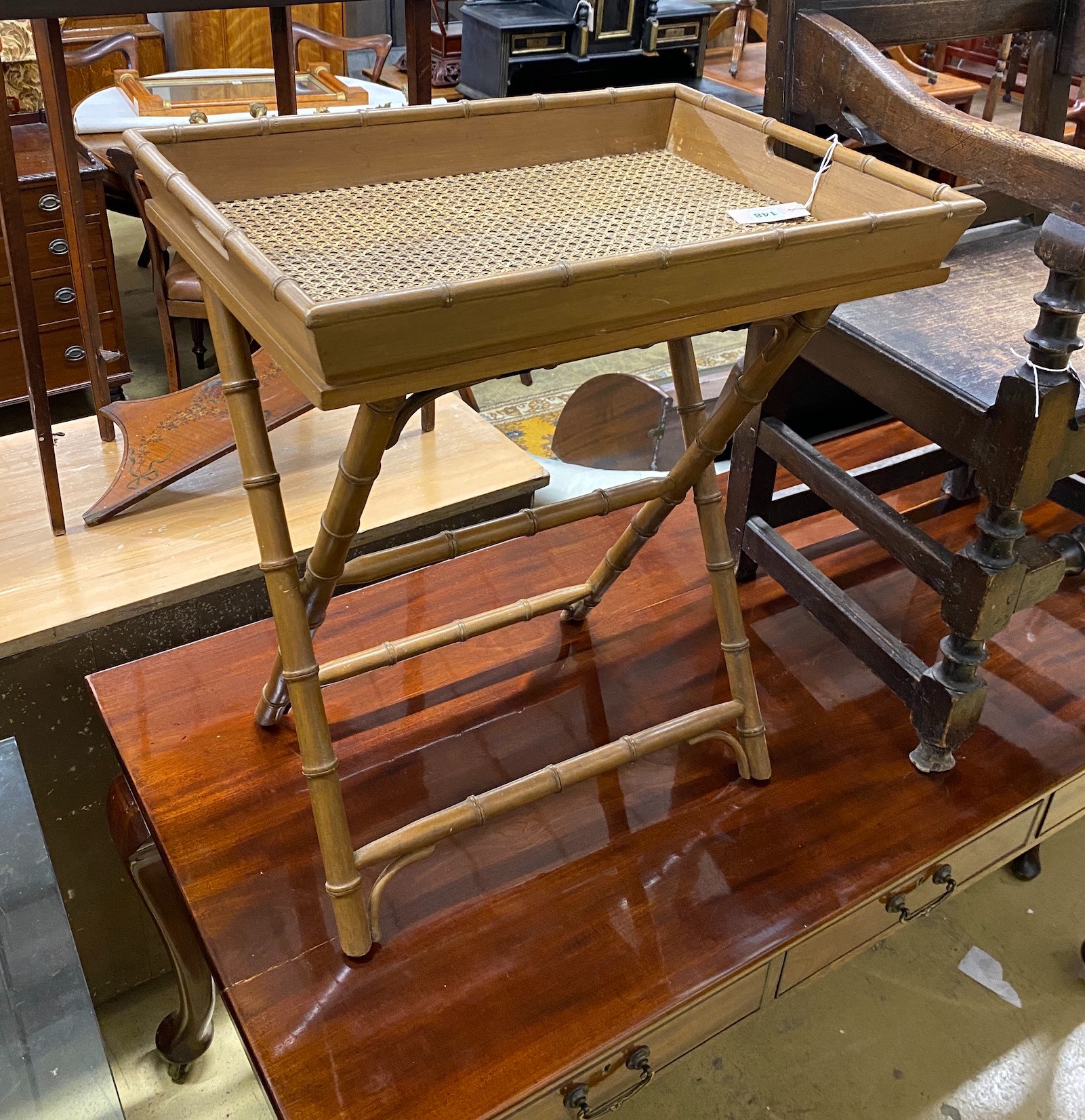 A faux bamboo caned butler's tray on folding stand, width 60cm, depth 43cm, height 68cm